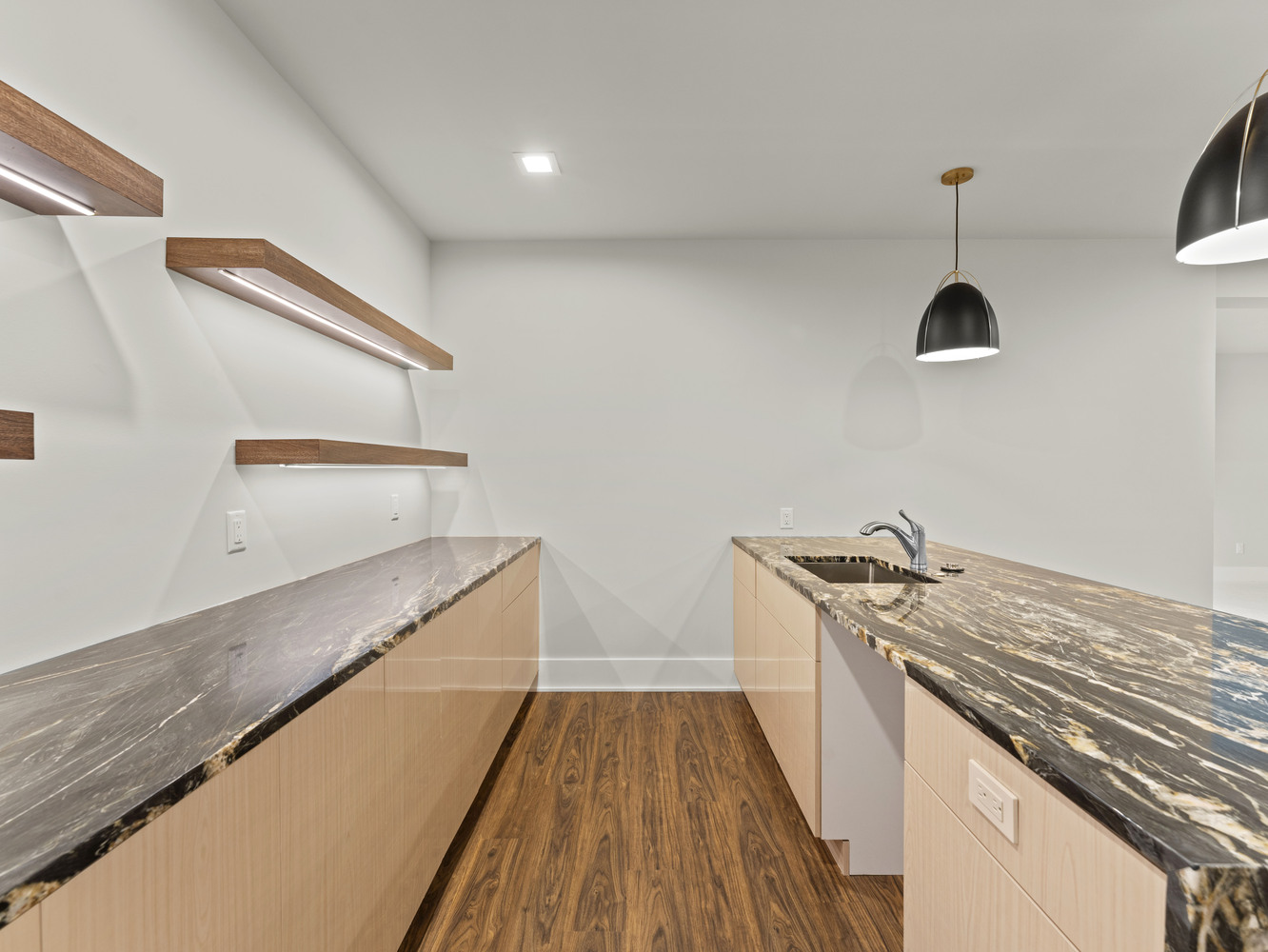 Side view of basement bar with sleek cabinetry and custom lighting by DesignLab in a Metro Washington custom home