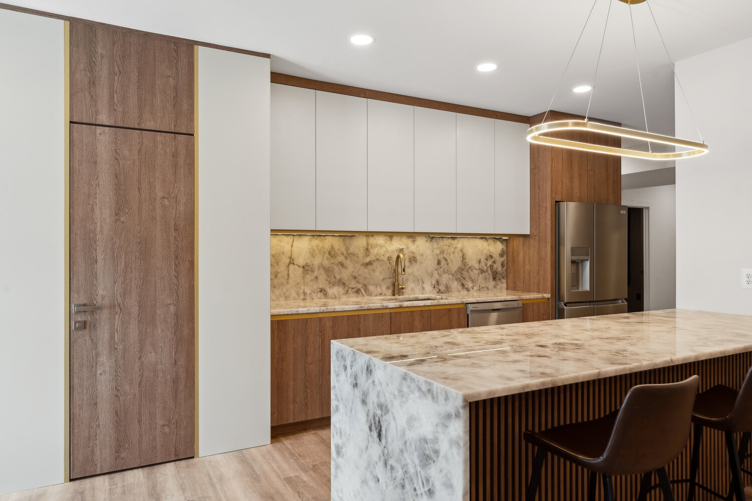 Sleek kitchen with white and wood cabinetry and marble backsplash by DesignLab in Capitol Hill, DC