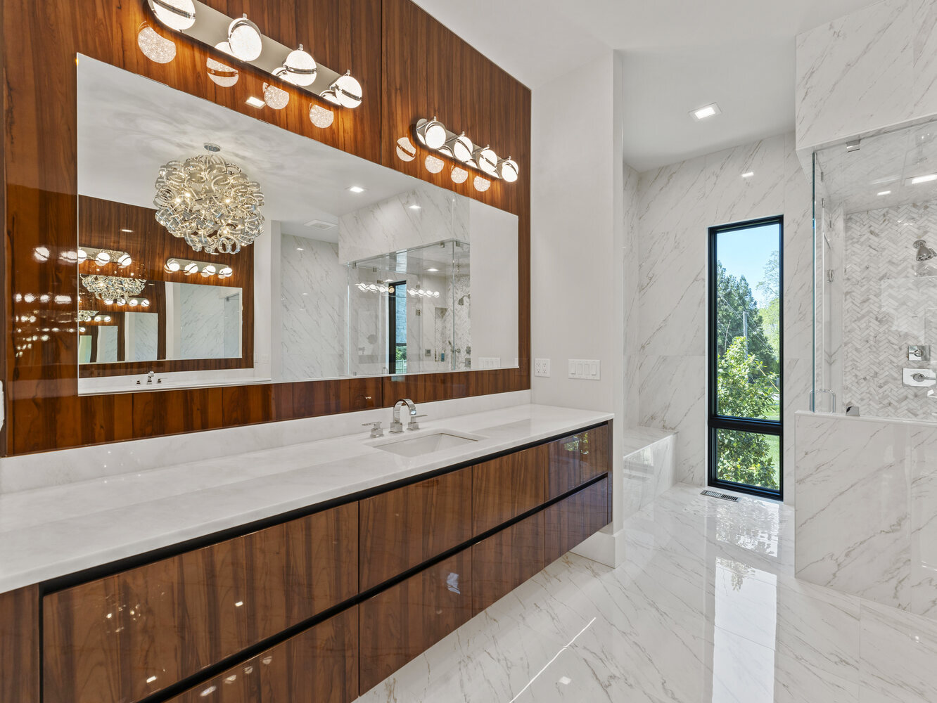 Luxe bathroom with full-height mirror and marble finishes in a DesignLab custom home in Bethesda, MD