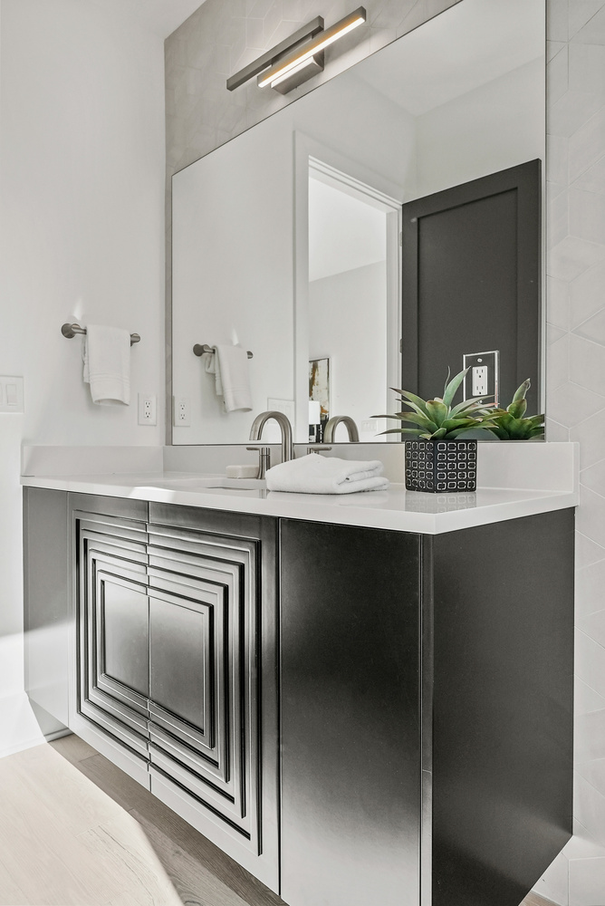 Modern vanity design with geometric cabinetry and white countertop in a DesignLab custom home in Fairfax County, VA