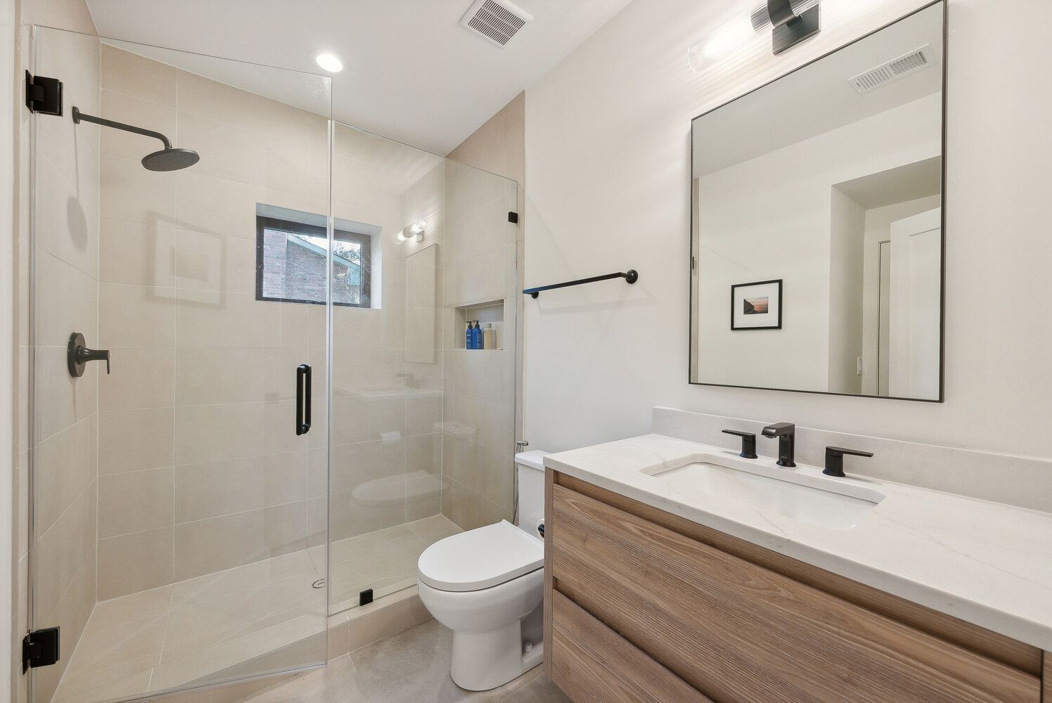 Neutral-toned bathroom with walk-in shower and floating vanity in a DesignLab custom home in Arlington, VA
