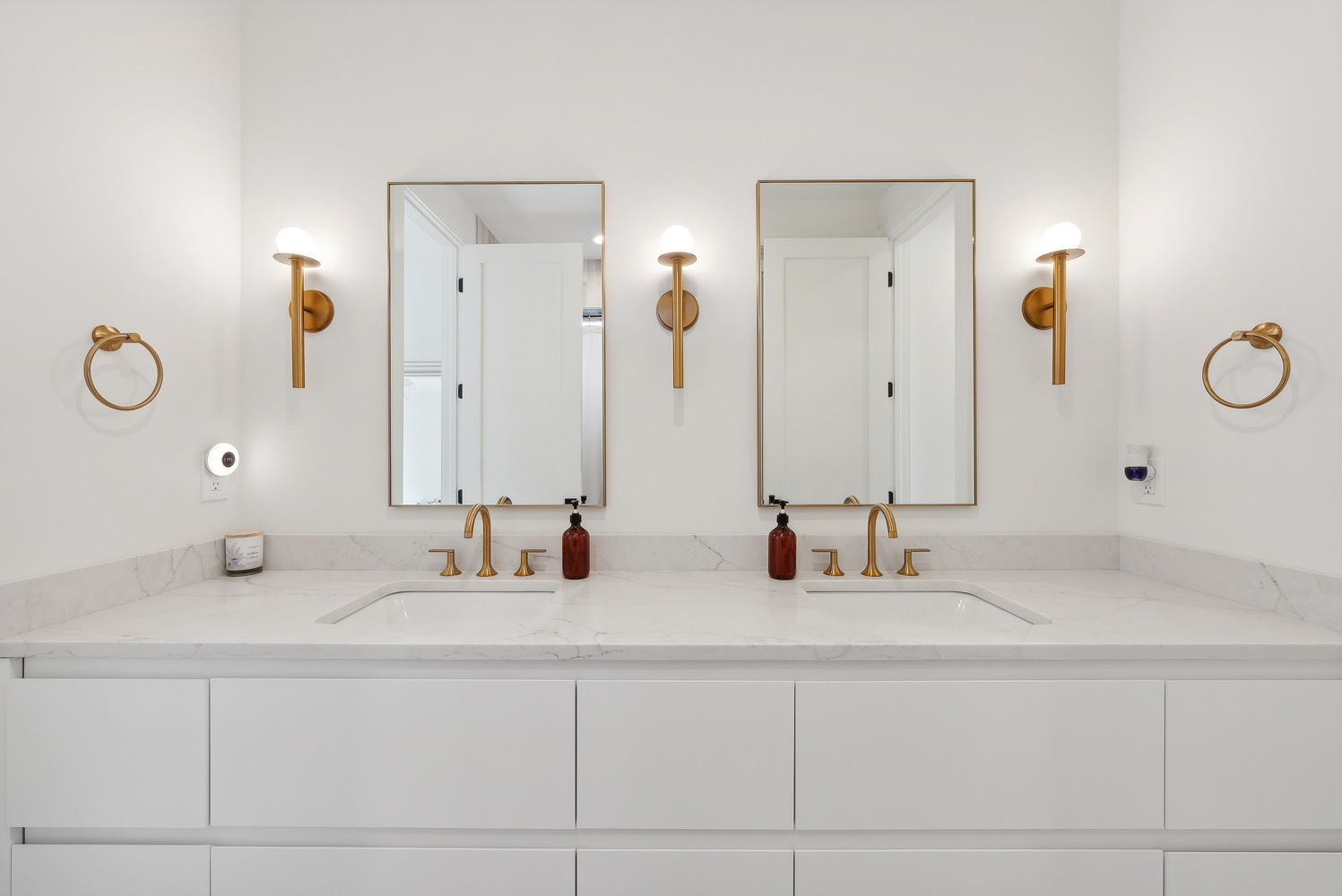 White dual vanity bathroom with gold fixtures in a DesignLab custom home in Falls Church, VA