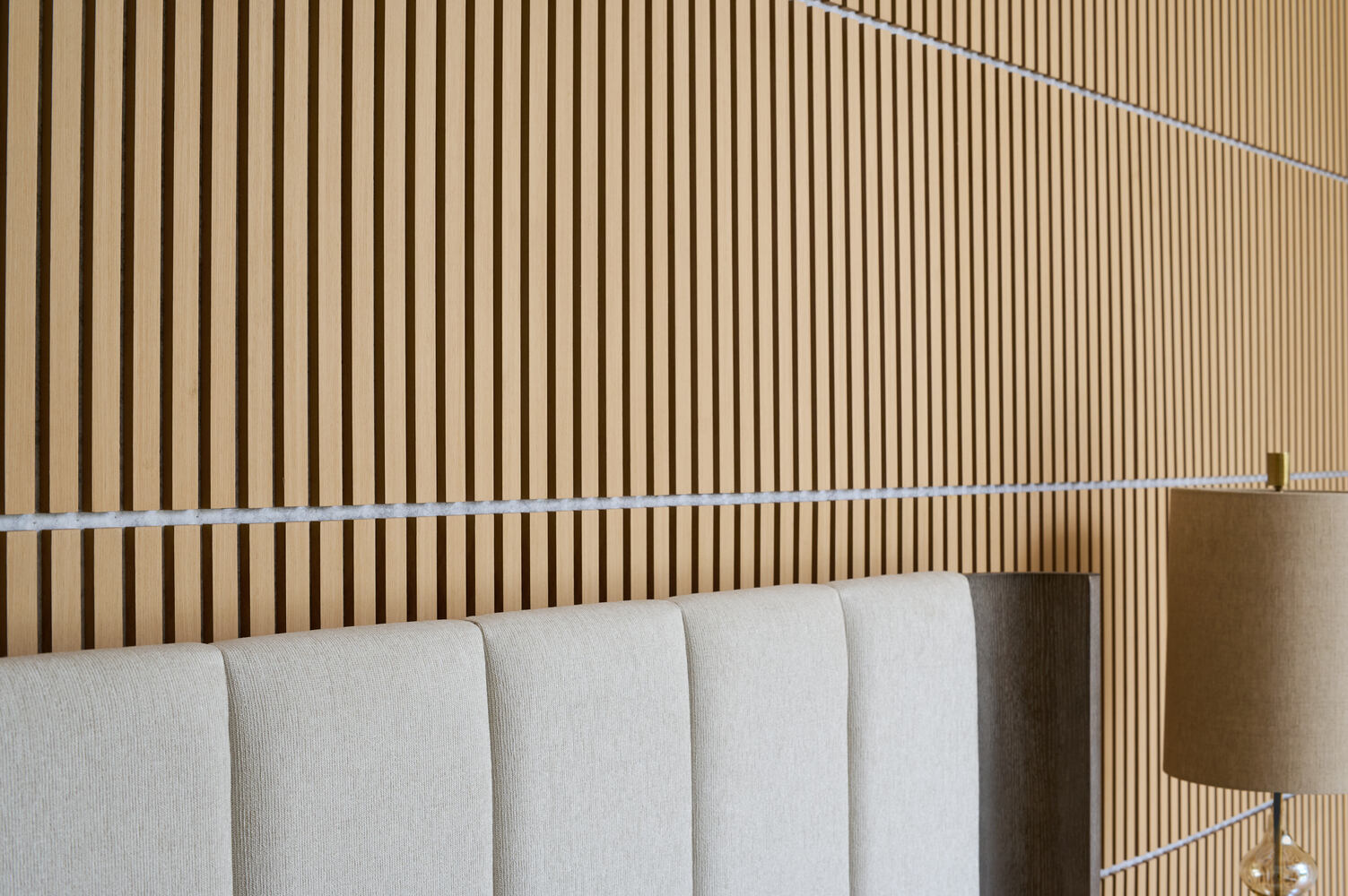 Contemporary vertical wood paneling adds warmth to a bedroom renovation by DesignLab in Chevy Chase, DC