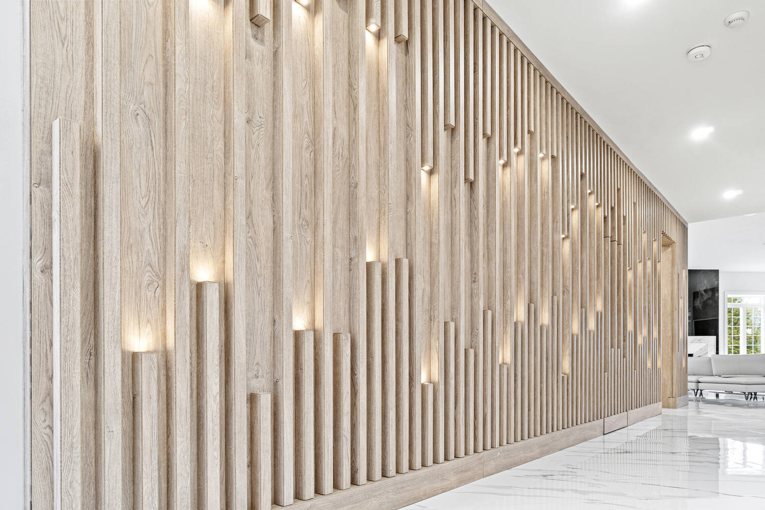Light-toned wood slat feature wall with integrated lighting in DesignLab custom home in Oakton, VA